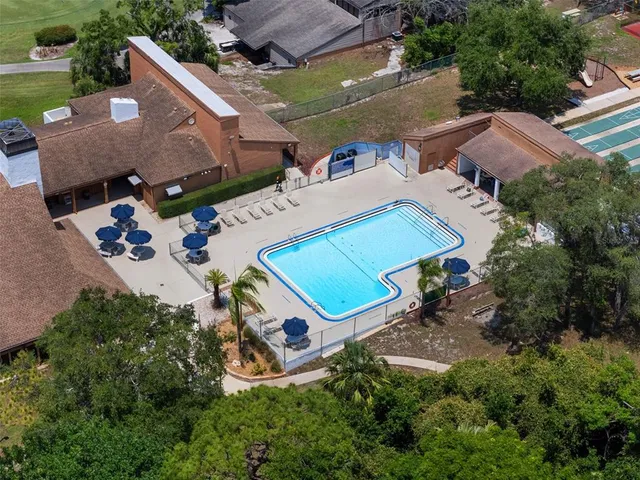 an aerial view of a tennis ground and a yard