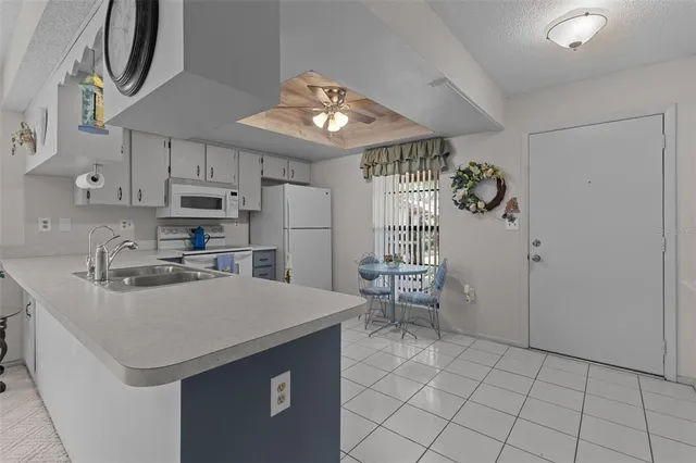 a kitchen with stainless steel appliances a refrigerator sink and microwave