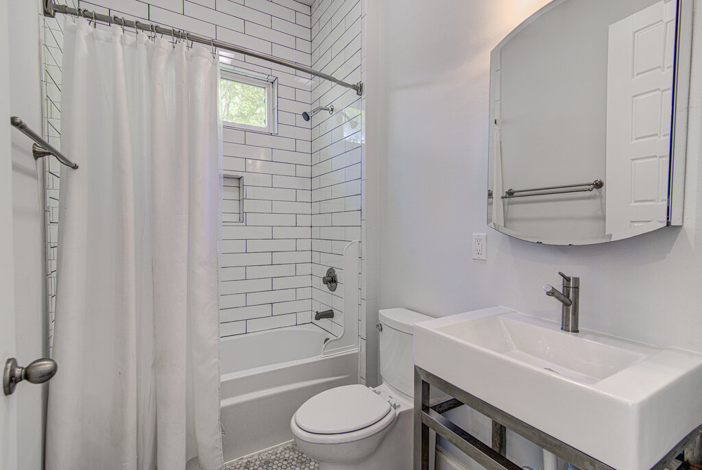 2406 East 16th Street Austin, TX 78702 - Photo 20 of 39 a bathroom with a sink a toilet and shower