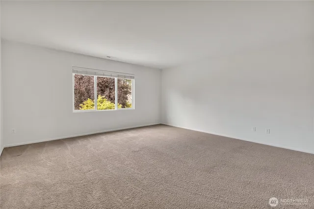 a bedroom with a bed couch and window