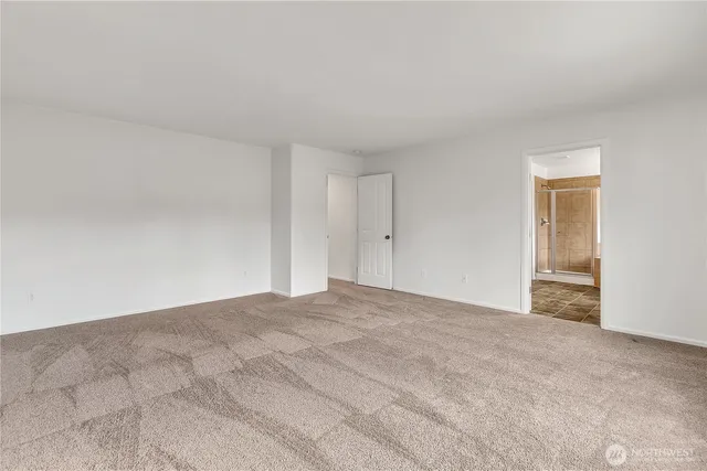 a spacious bathroom with a bathtub shower sink mirror and toilet
