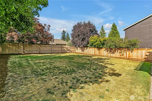 a view of a house with a yard and plants