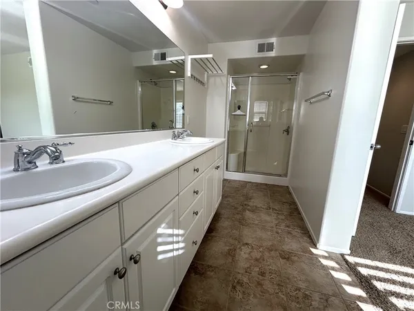 a bathroom with a double vanity sink and mirror