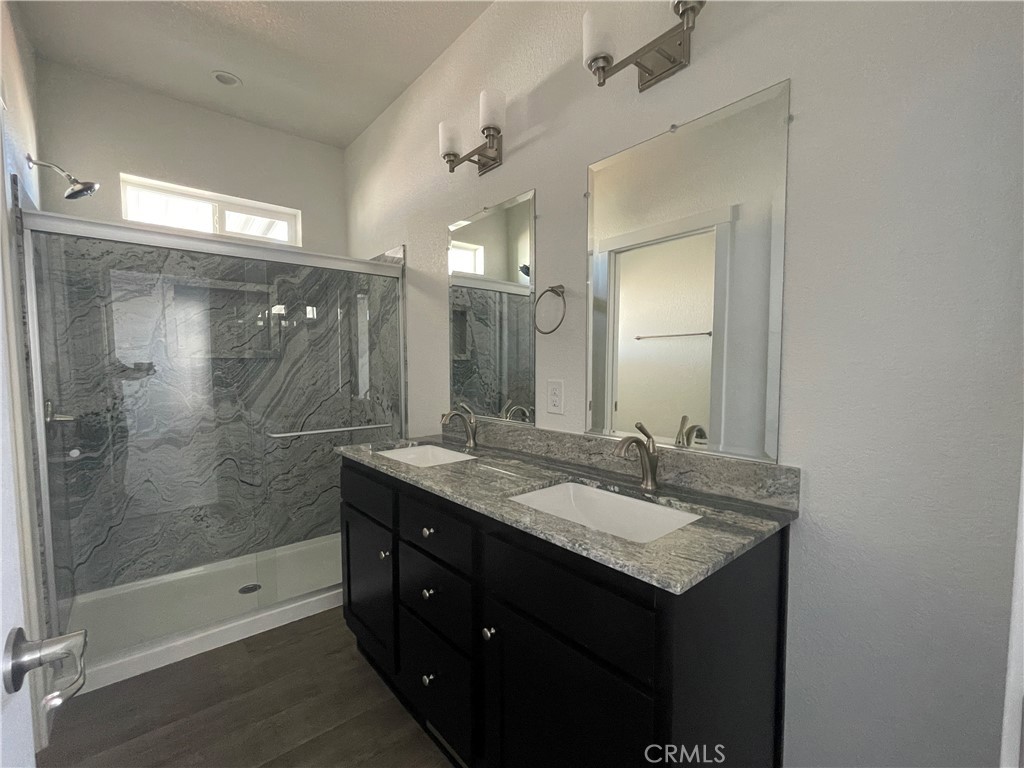 3500 Buchanan Street, Unit 138 Riverside, CA 92503 - Photo 9 of 18 a bathroom with a granite countertop sink mirror and shower