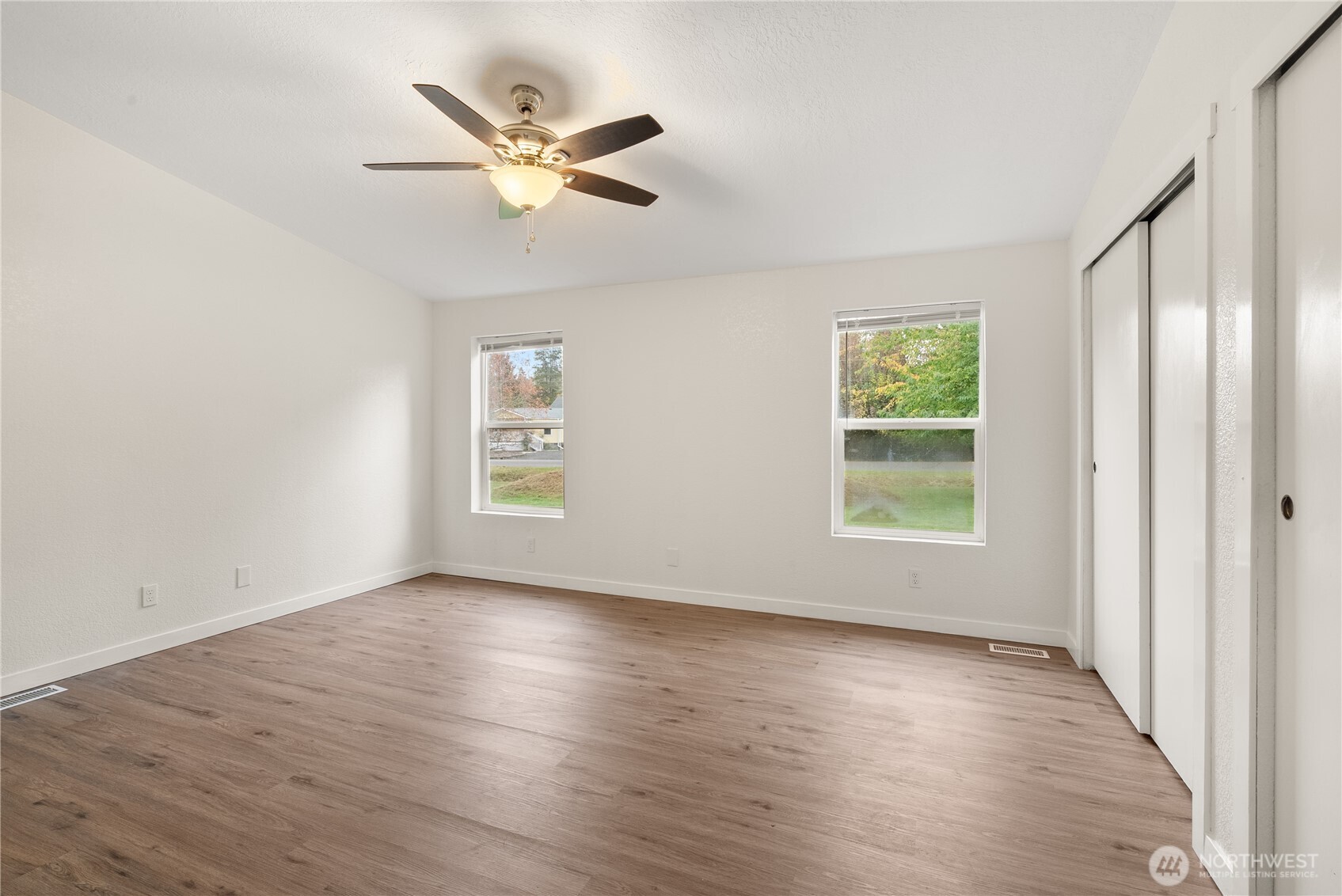 11727 Driver Street Southwest Olympia, WA 98512 - Photo 15 of 33 an empty room with wooden floor fan and windows