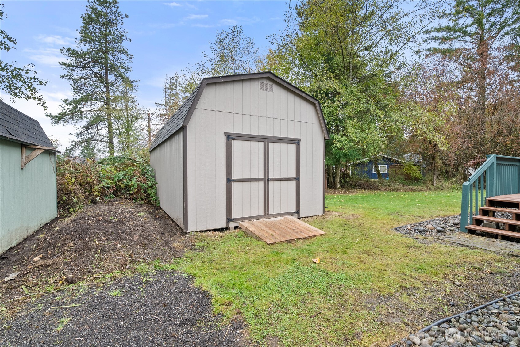 11727 Driver Street Southwest Olympia, WA 98512 - Photo 23 of 35 a view of backyard with a barn and large trees