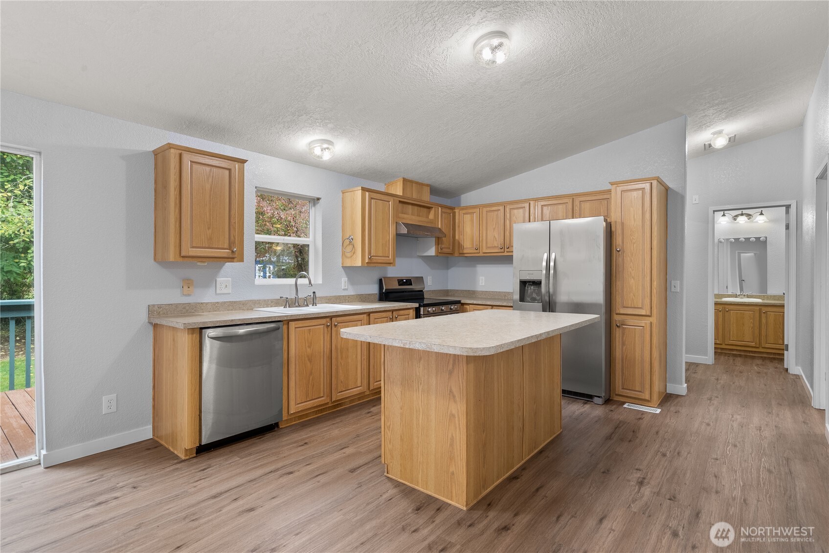 11727 Driver Street Southwest Olympia, WA 98512 - Photo 6 of 33 a kitchen with a refrigerator a sink and wooden floor