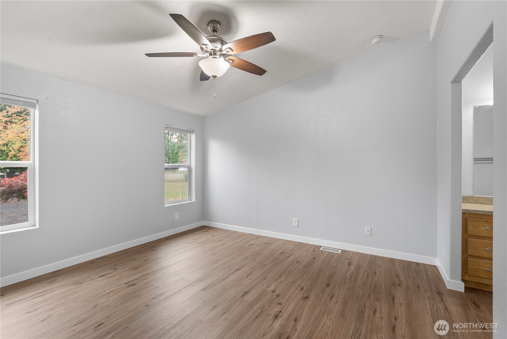 11727 Driver Street Southwest Olympia, WA 98512 - Photo 10 of 33 an empty room with wooden floor fan and windows