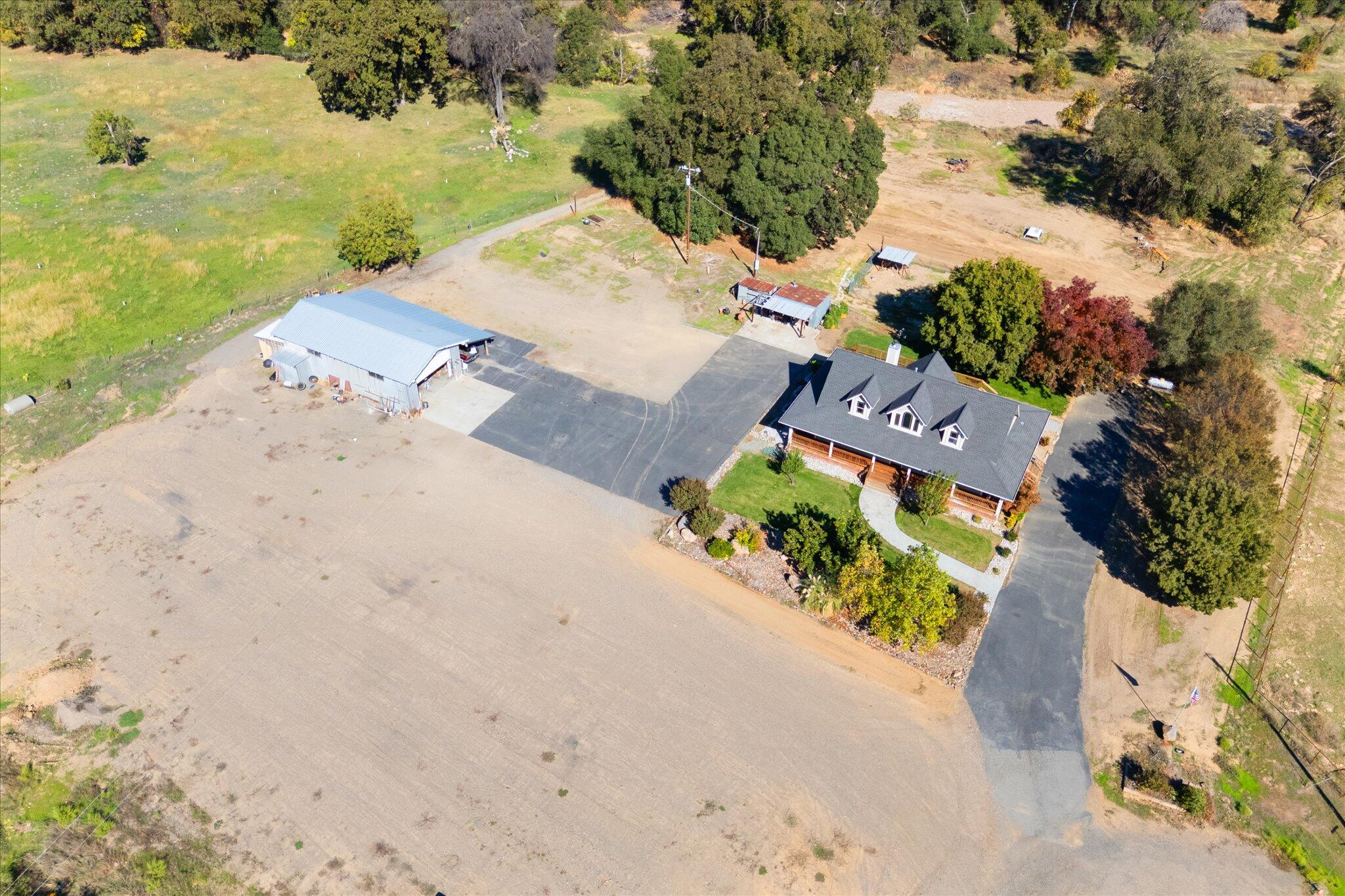 an aerial view of a house with a yard and lake view