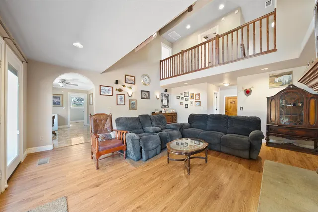 a living room with furniture and a ceiling fan
