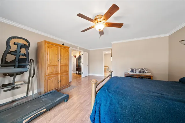 a view of a livingroom with wooden floor and a ceiling fan
