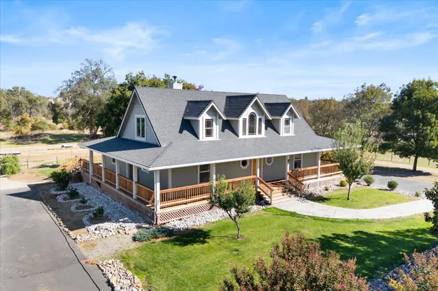 a front view of a house with a garden and swimming pool