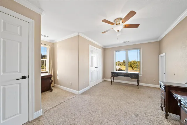 a view of empty room with ceiling fan