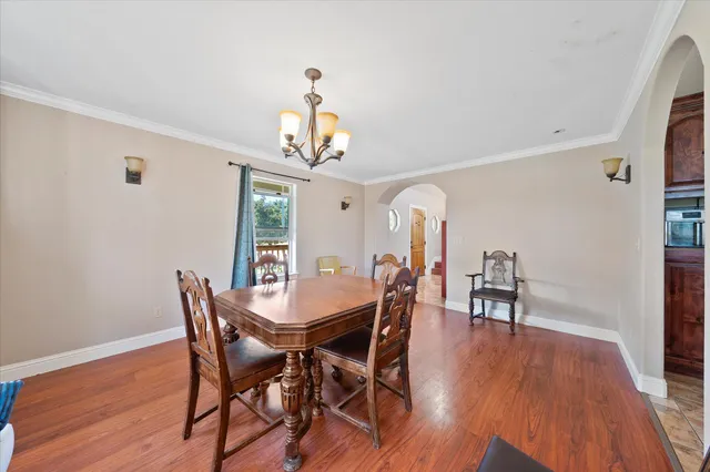 a view of a dining room with furniture and wooden floor