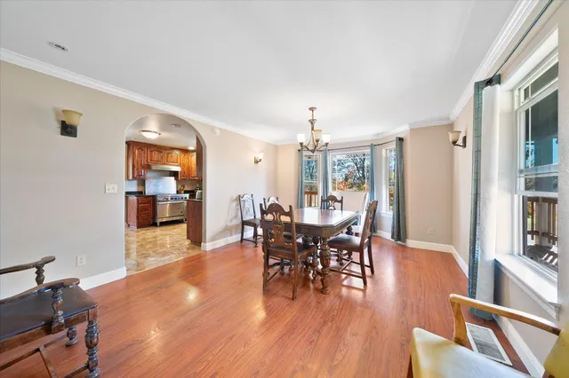 a view of a dining room with furniture window and wooden floor