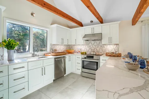 a kitchen with a sink cabinets and window