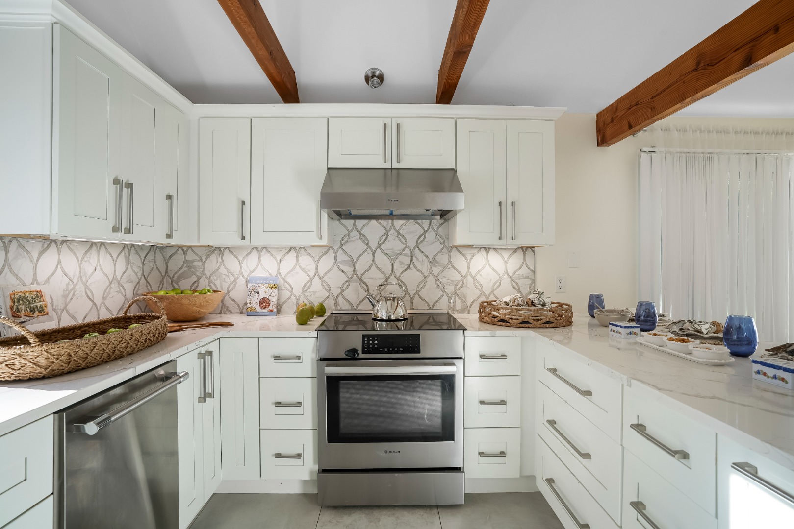 105 Stoney Hill Road West Tisbury, MA 02568 - Photo 13 of 44 a kitchen with granite countertop white cabinets and stainless steel appliances