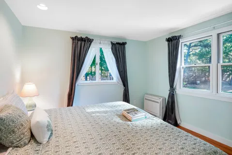 a bedroom with a bed and window