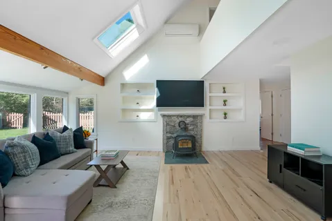 a living room with furniture and a fireplace or television