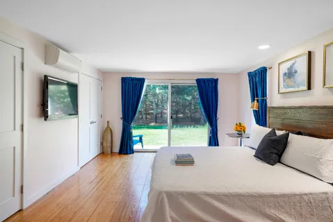 a bedroom with a bed and a large window