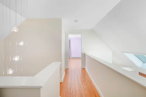 a view of hallway with wooden floor