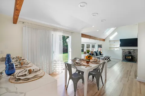a view of a dining room with furniture window and wooden floor