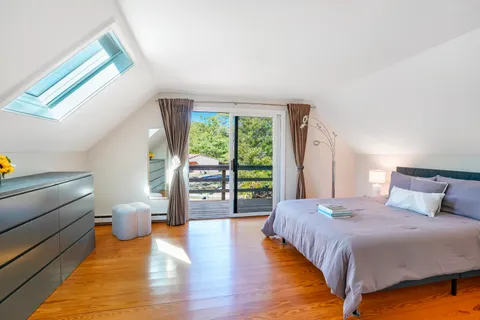 a bedroom with a large bed and a large window