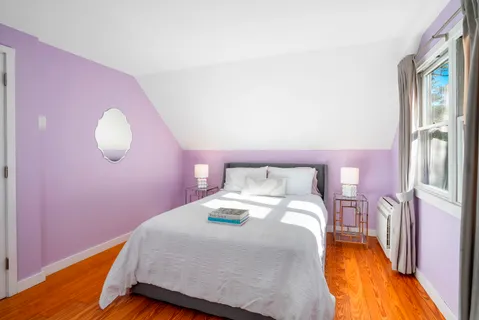 a bedroom with a bed and a chair