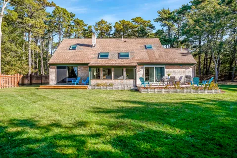 a front view of a house with a yard table and chairs