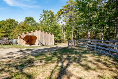 a backyard of a house with table and chairs
