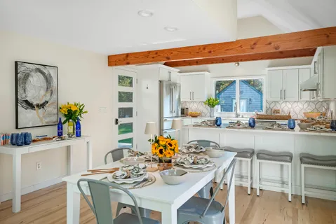a dining room with furniture and wooden floor