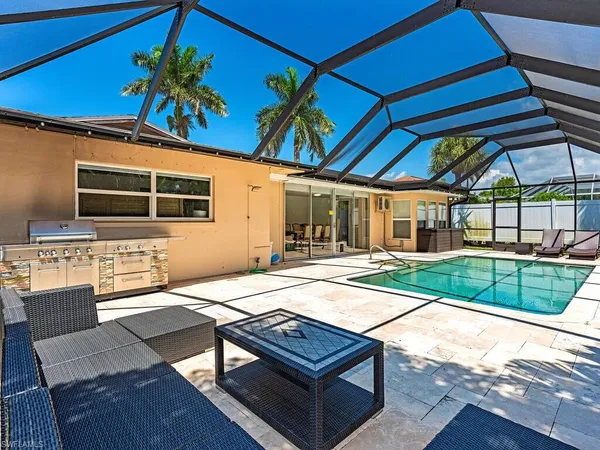a view of a backyard with table and chairs