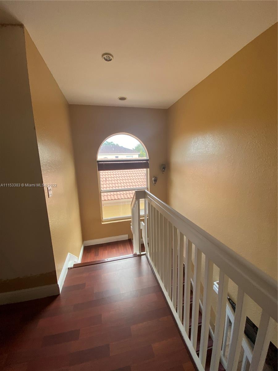 2101 Northeast 37th Road Homestead, FL 33033 - Photo 3 of 11 a view of hallway with stairs and wooden floor