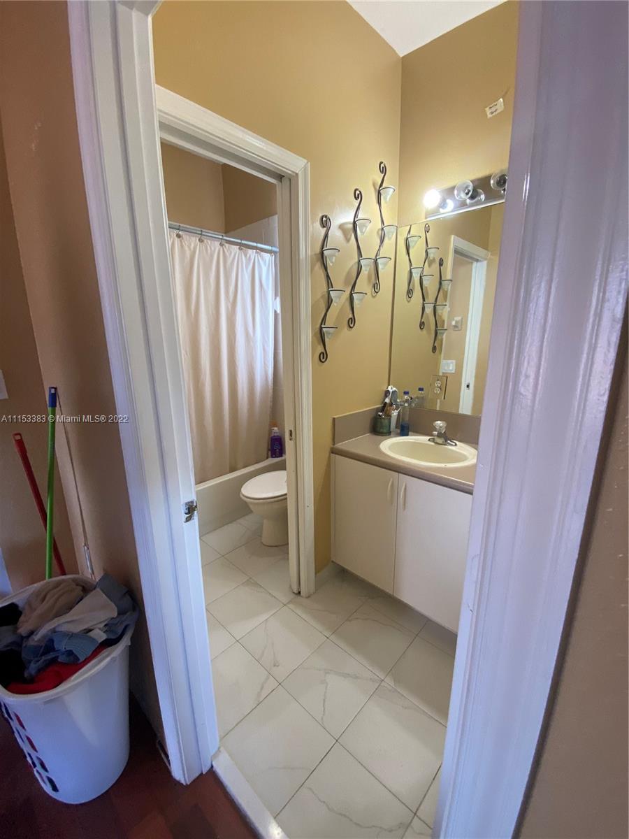2101 Northeast 37th Road Homestead, FL 33033 - Photo 6 of 11 a bathroom with a sink a toilet and shower