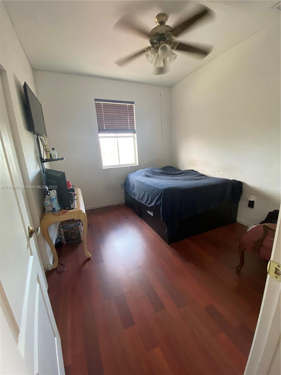 2101 Northeast 37th Road Homestead, FL 33033 - Photo 9 of 11 a bedroom with a bed and a window