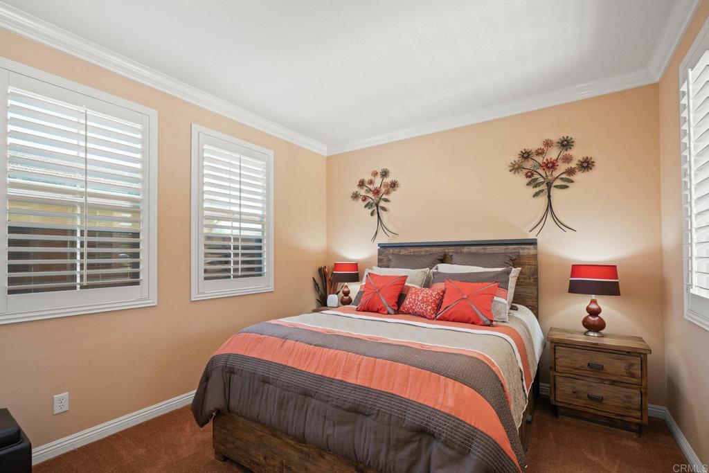 5191 Cobalt Way Oceanside, CA 92057 - Photo 29 of 61 a bedroom with a bed and wooden floor