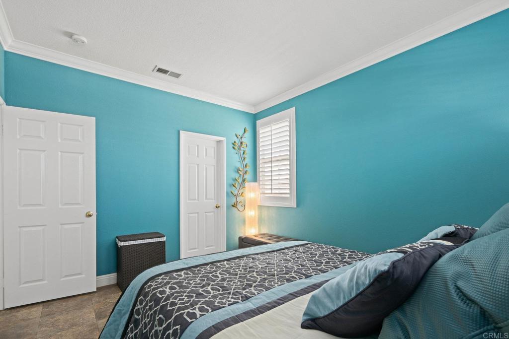 5191 Cobalt Way Oceanside, CA 92057 - Photo 35 of 61 a bedroom with a bed and a window