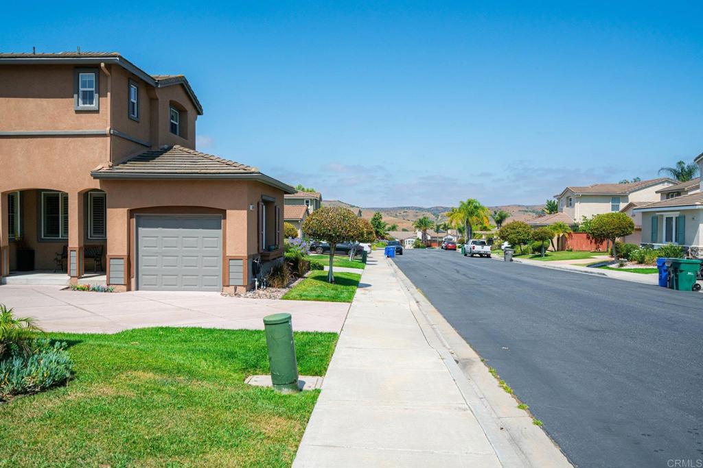 5191 Cobalt Way Oceanside, CA 92057 - Photo 6 of 61 a front view of a house with a yard and garage