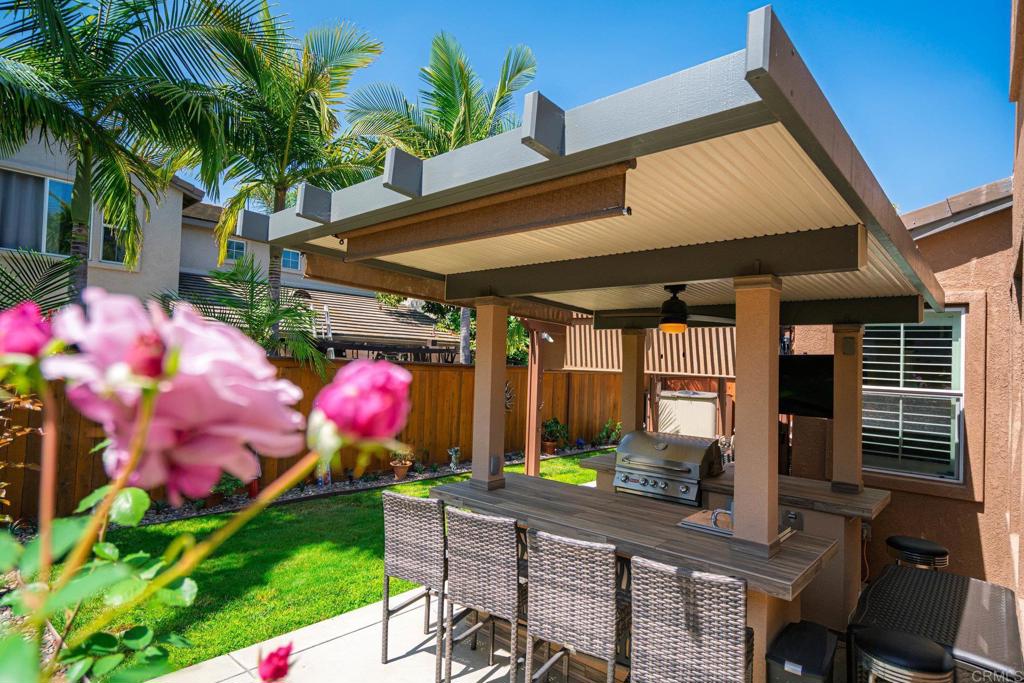 5191 Cobalt Way Oceanside, CA 92057 - Photo 61 of 61 a patio with table and chairs potted plants
