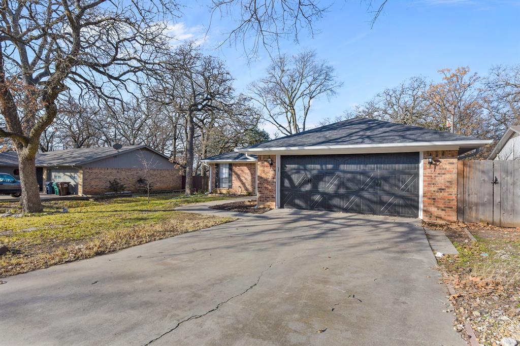 a view of a house with a yard and garage