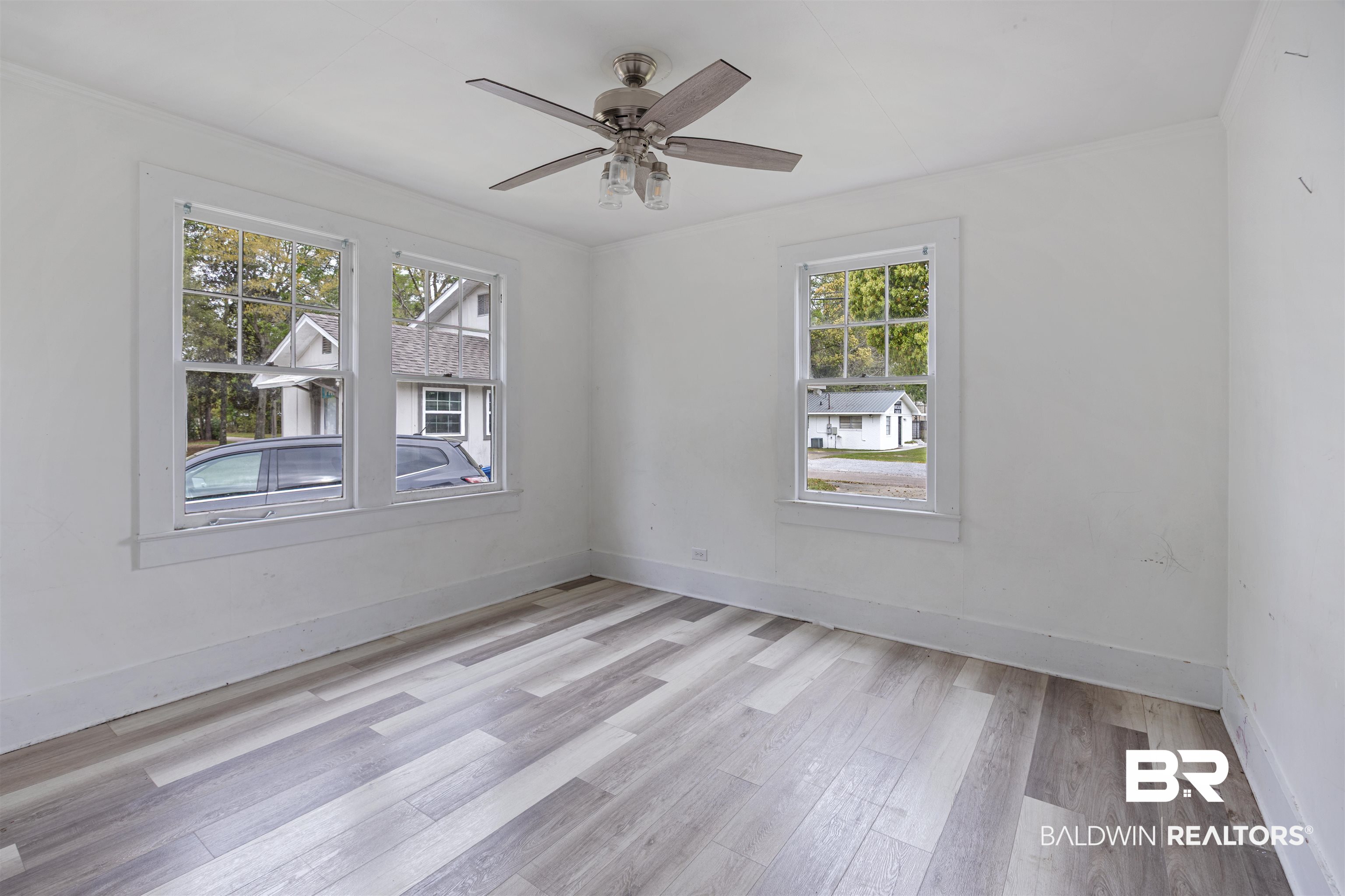 112 South Juniper Street Foley, AL 36535 - Photo 26 of 64 Spare room featuring light wood-style floors, a ceiling fan, and crown molding