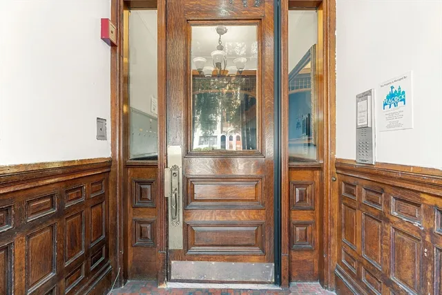 a front view of a residential apartment building with a yard