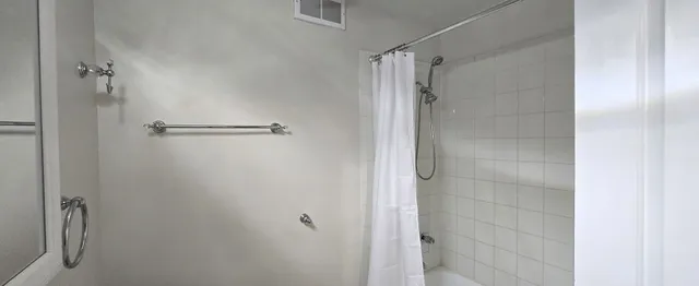 a bathroom with a glass shower door