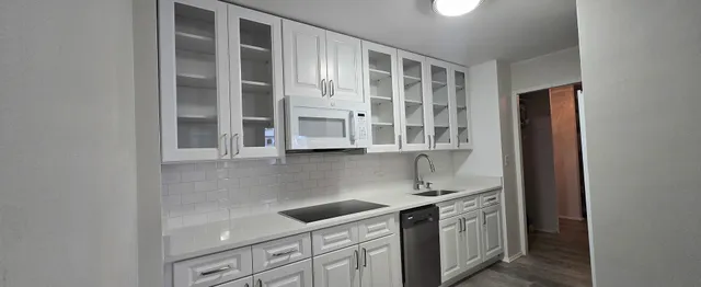 a kitchen with stainless steel appliances granite countertop a stove and a refrigerator