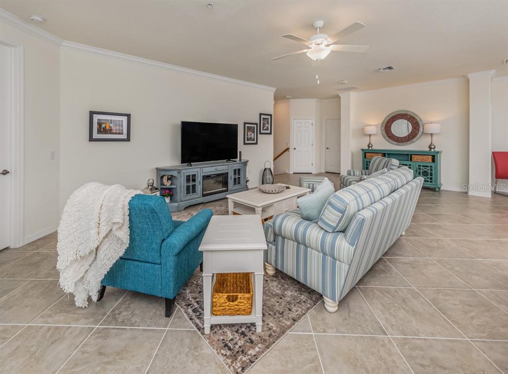 12550 Ghiberti Circle, Unit 201 Venice, FL 34293 - Photo 12 of 44 a living room with furniture and a flat screen tv