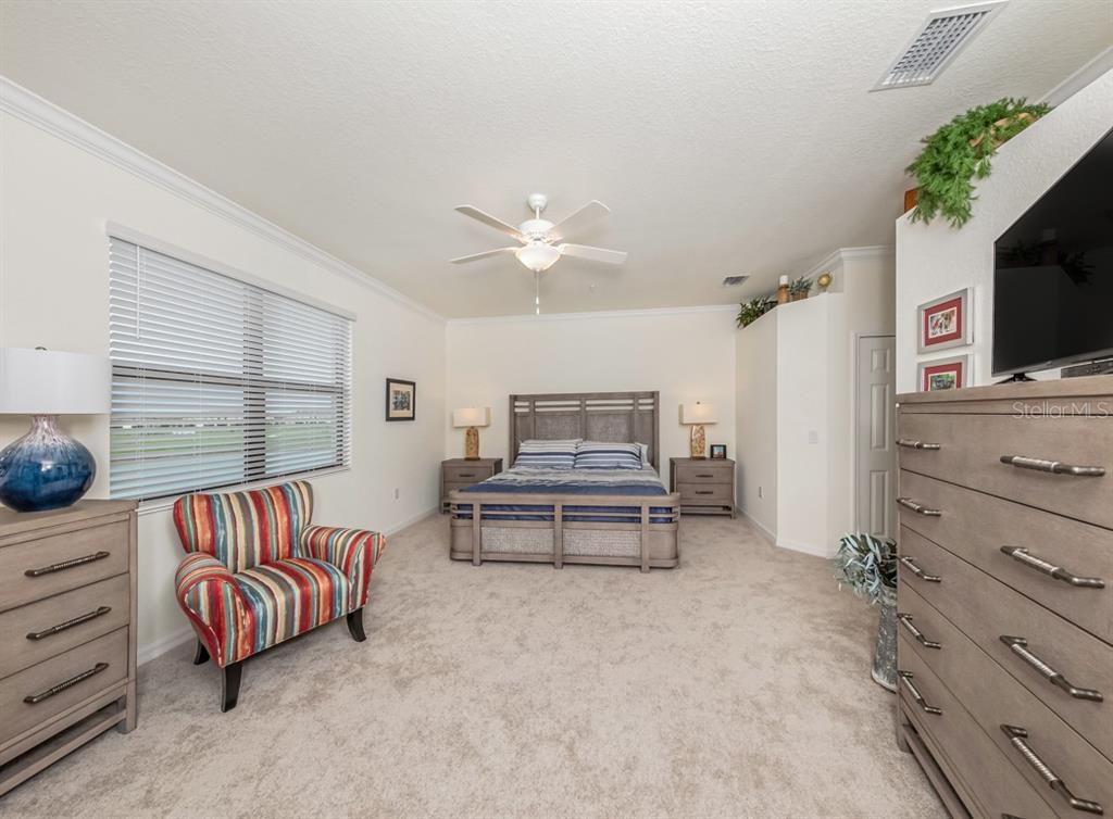 12550 Ghiberti Circle, Unit 201 Venice, FL 34293 - Photo 16 of 44 a living room with furniture and a flat screen tv