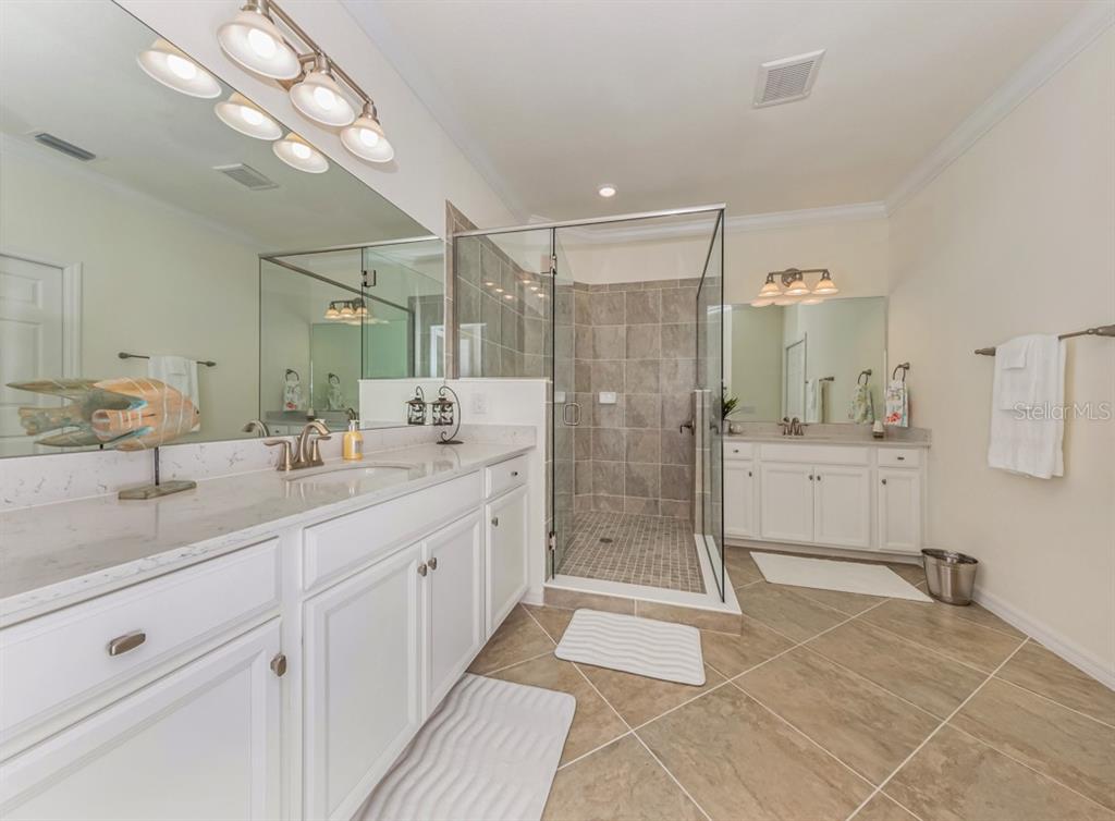 12550 Ghiberti Circle, Unit 201 Venice, FL 34293 - Photo 17 of 44 a spacious bathroom with a shower sink mirror and