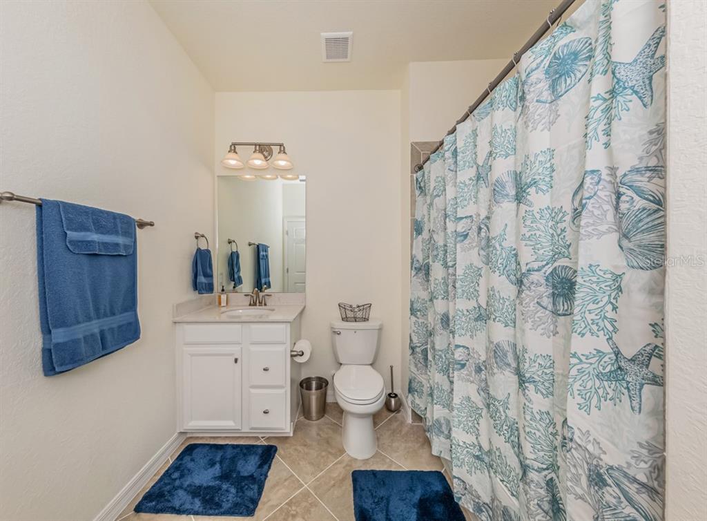 12550 Ghiberti Circle, Unit 201 Venice, FL 34293 - Photo 19 of 44 a bathroom with a toilet and a shower