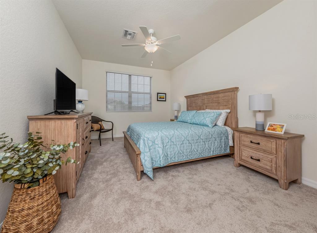 12550 Ghiberti Circle, Unit 201 Venice, FL 34293 - Photo 20 of 44 a bedroom with a bed and flat screen tv