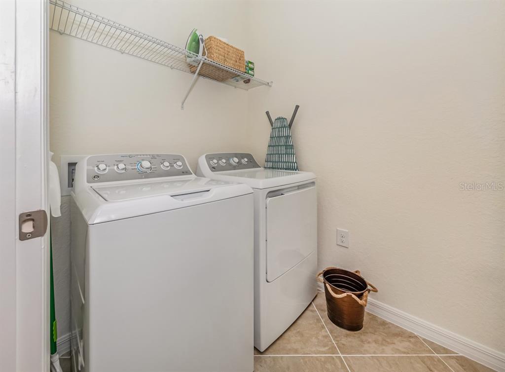12550 Ghiberti Circle, Unit 201 Venice, FL 34293 - Photo 21 of 44 a utility room with dryer and washer